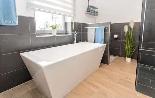 Modernes Bad mit freistehender Wanne und abgestimmten Materialien